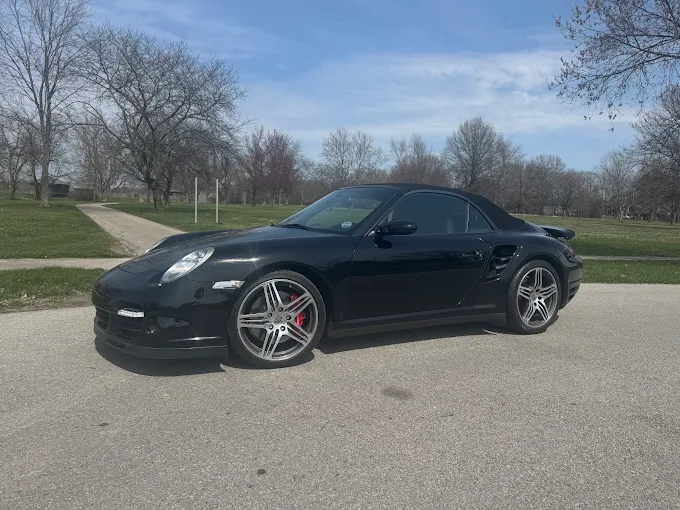 Black Porsche 911 Turbo cabriolet parked outdoors