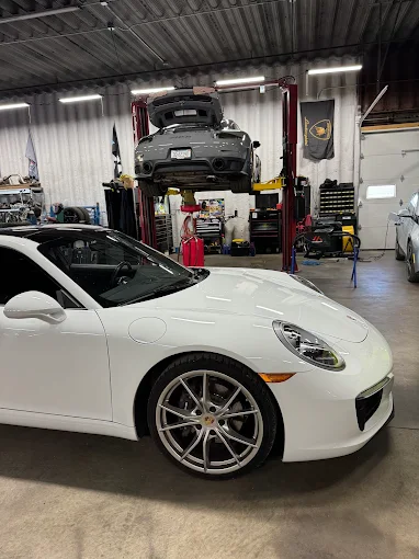 White Porsche 911 inside the MMr Autosport workshop