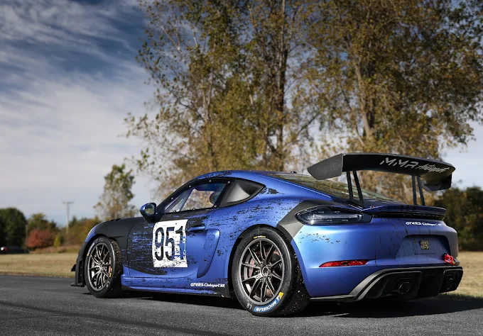 Blue number 951 Porsche Cayman GT4 RS Clubsport parked outside, rear angle