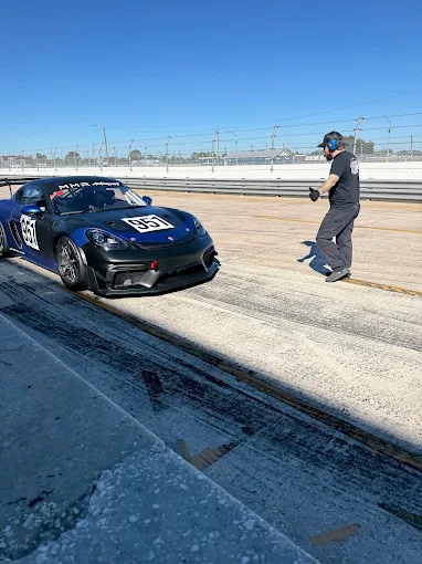 The number 951 Porsche race car on pit lane at the track